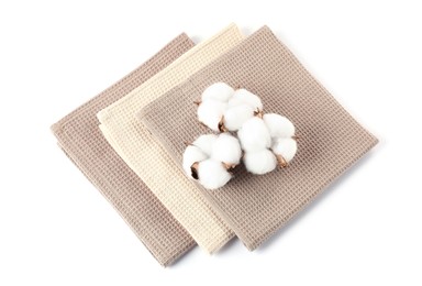 Photo of Clean waffle towels and cotton flowers isolated on white, above view
