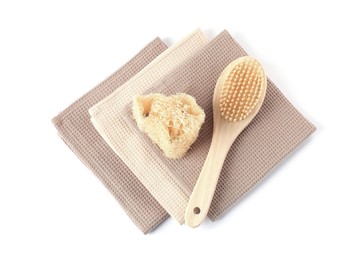 Photo of Clean waffle towels, brush and loofah isolated on white, top view