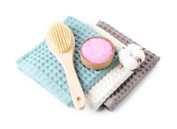 Photo of Clean waffle towels, cotton flower and spa products isolated on white