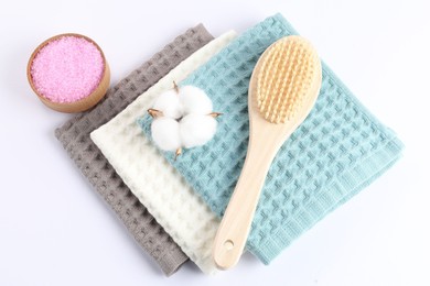 Photo of Clean waffle towels, cotton flower and spa products on white background, flat lay