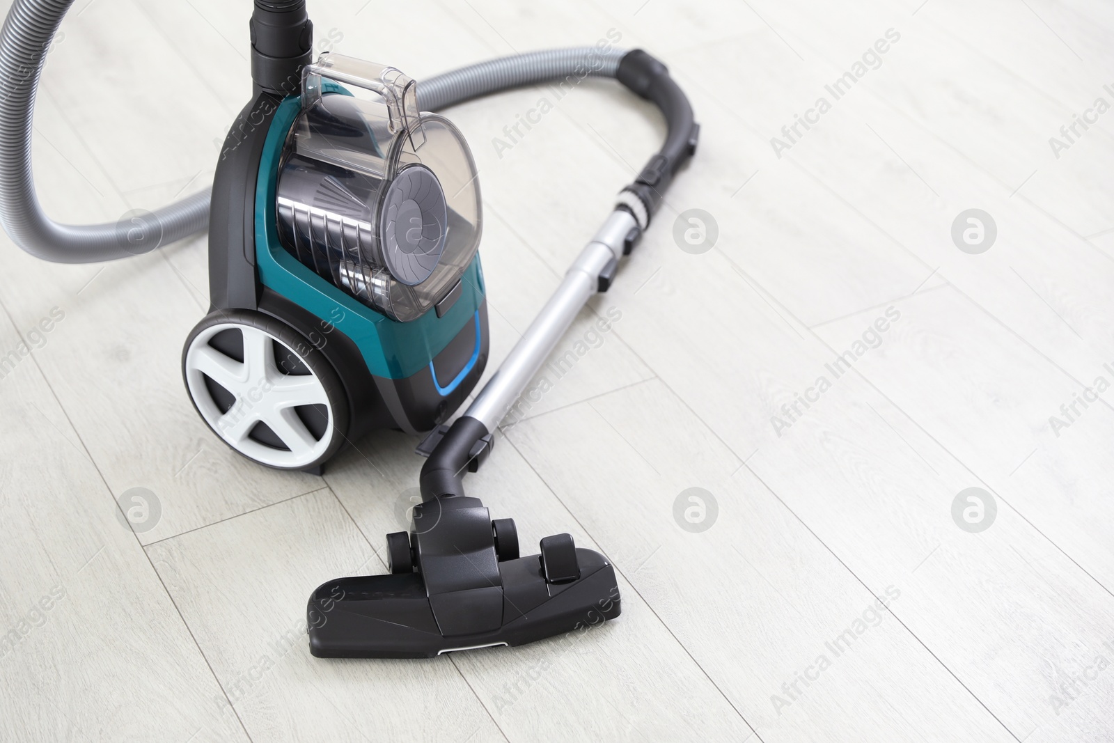 One vacuum cleaner on wooden floor. Household appliance Photo of One vacuum cleaner on wooden floor. Household appliance