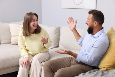 Photo of Friends laughing on sofa at home. Positive emotion