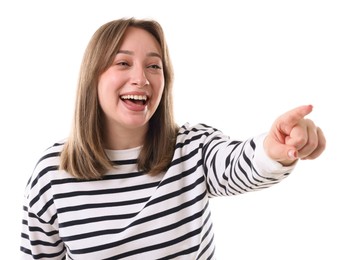 Photo of Attractive woman pointing at something and laughing on white background
