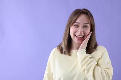 Photo of Attractive woman laughing on violet background. Space for text