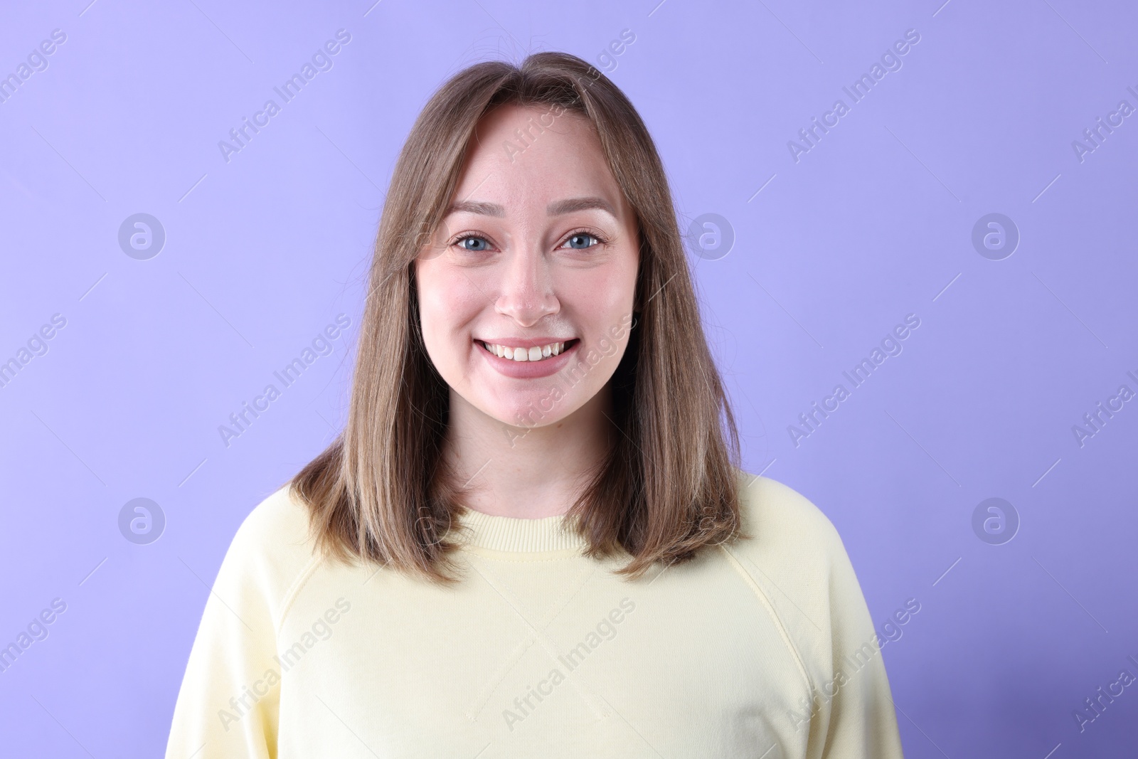 Photo of Attractive woman laughing on violet background. Positive emotion