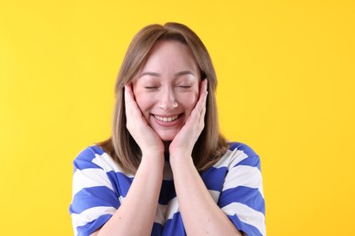 Photo of Attractive woman laughing on yellow background. Positive emotion