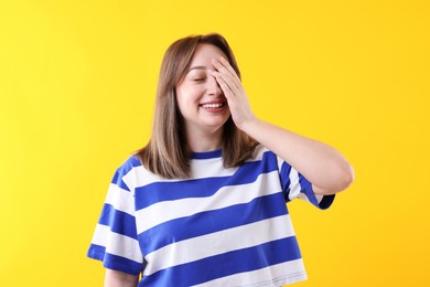 Photo of Attractive woman laughing on yellow background. Positive emotion