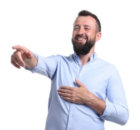 Photo of Handsome man pointing at something and laughing on white background