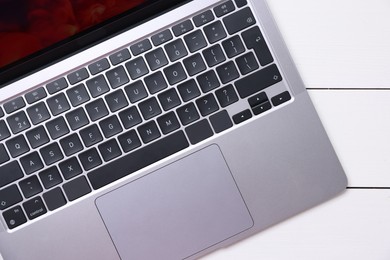 Photo of Laptop keyboard on white wooden table, top view