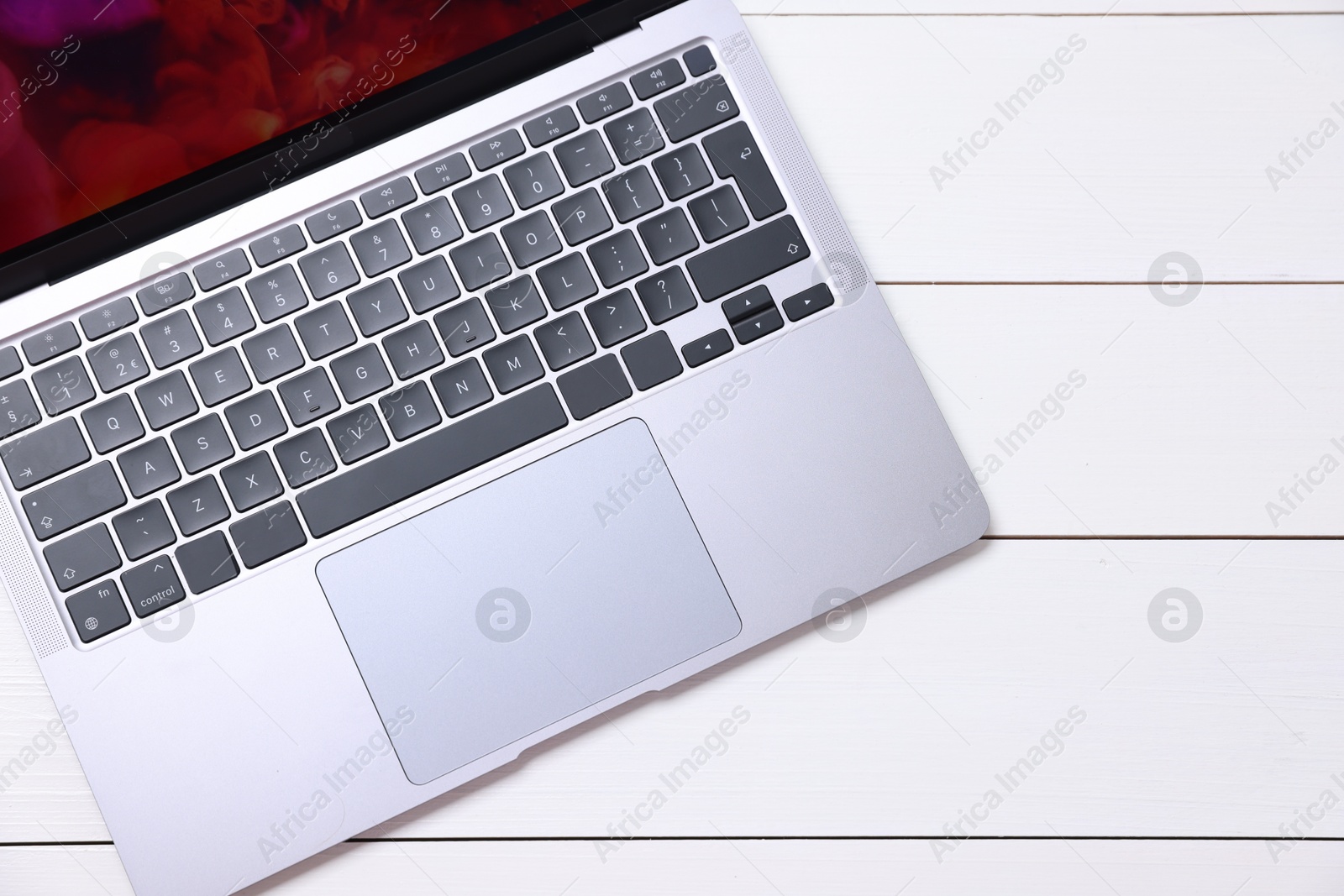 Laptop keyboard on white wooden table, top view. Space for text Photo of Laptop keyboard on white wooden table, top view. Space for text