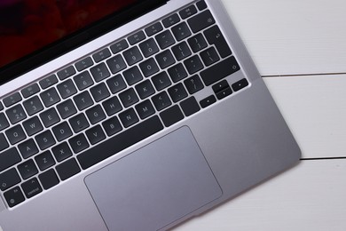 Photo of Laptop keyboard on white wooden table, top view