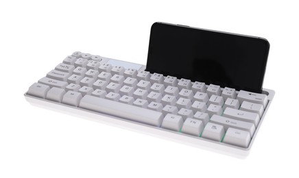 Photo of Modern computer keyboard with RGB lighting and smartphone isolated on white