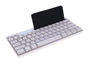 Photo of Modern computer keyboard with RGB lighting and smartphone isolated on white