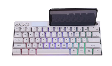 Photo of Modern computer keyboard with RGB lighting and smartphone isolated on white, above view