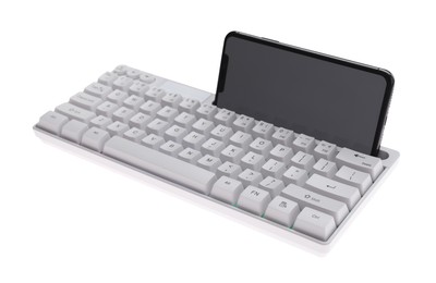 Photo of Modern computer keyboard with smartphone isolated on white