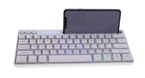 Photo of Modern computer keyboard with RGB lighting and smartphone isolated on white