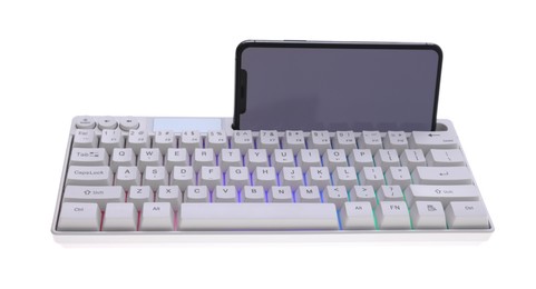 Photo of Modern computer keyboard with RGB lighting and smartphone isolated on white