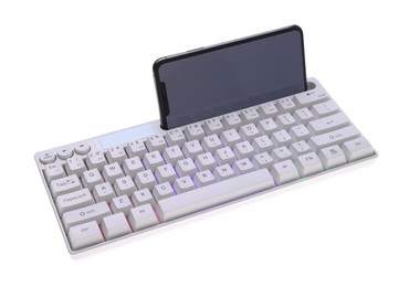 Photo of Modern computer keyboard with RGB lighting and smartphone isolated on white