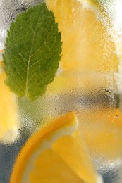 Photo of Soda water with orange and mint as background, closeup