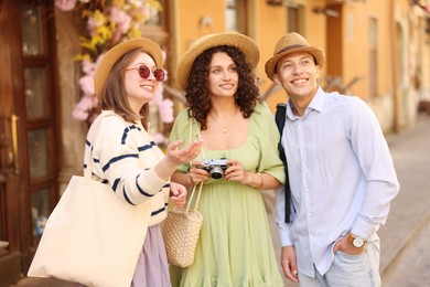 Photo of Guide and tourists on city street during excursion