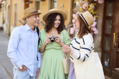 Photo of Guide and tourists on city street during excursion