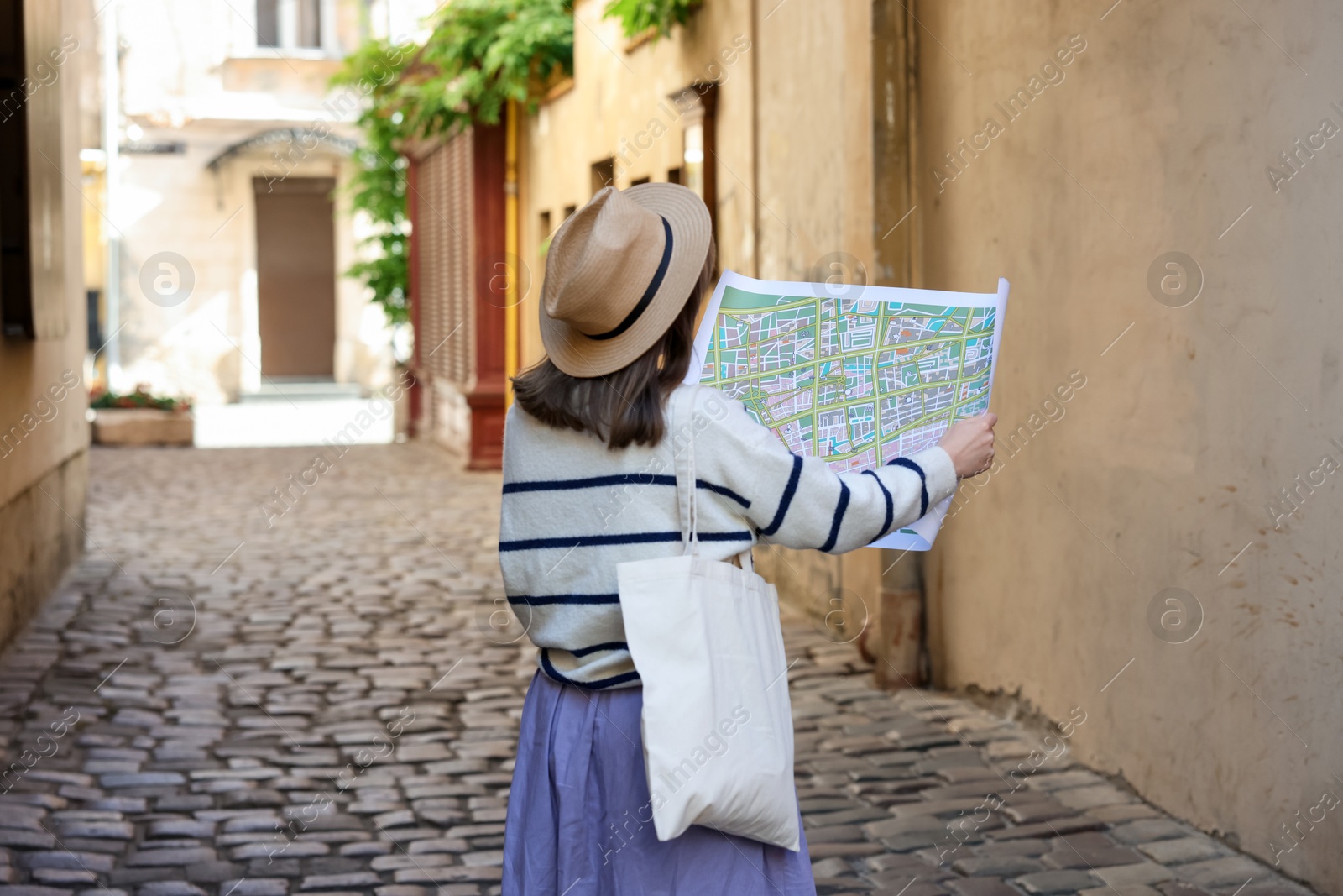 Photo of Tourist with map walking on city street