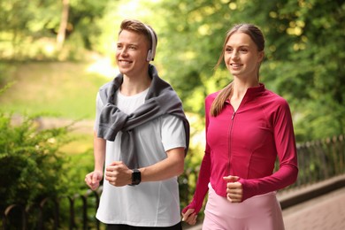 Photo of Happy couple running in park. Morning exercise
