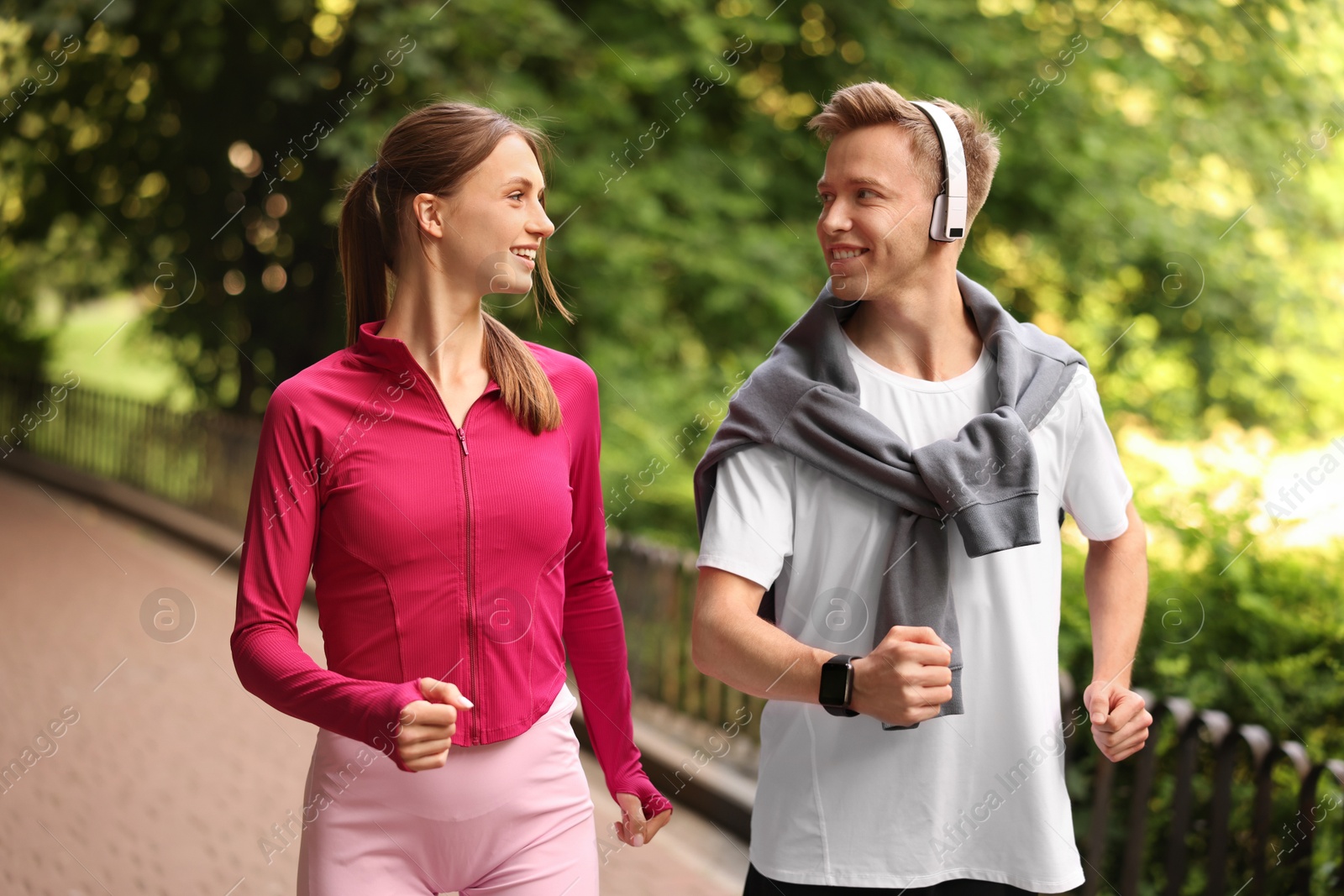 Photo of Happy couple running in park. Morning exercise