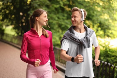 Photo of Happy couple running in park. Morning exercise