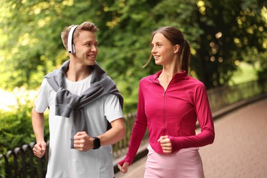 Photo of Happy couple running in park. Morning exercise