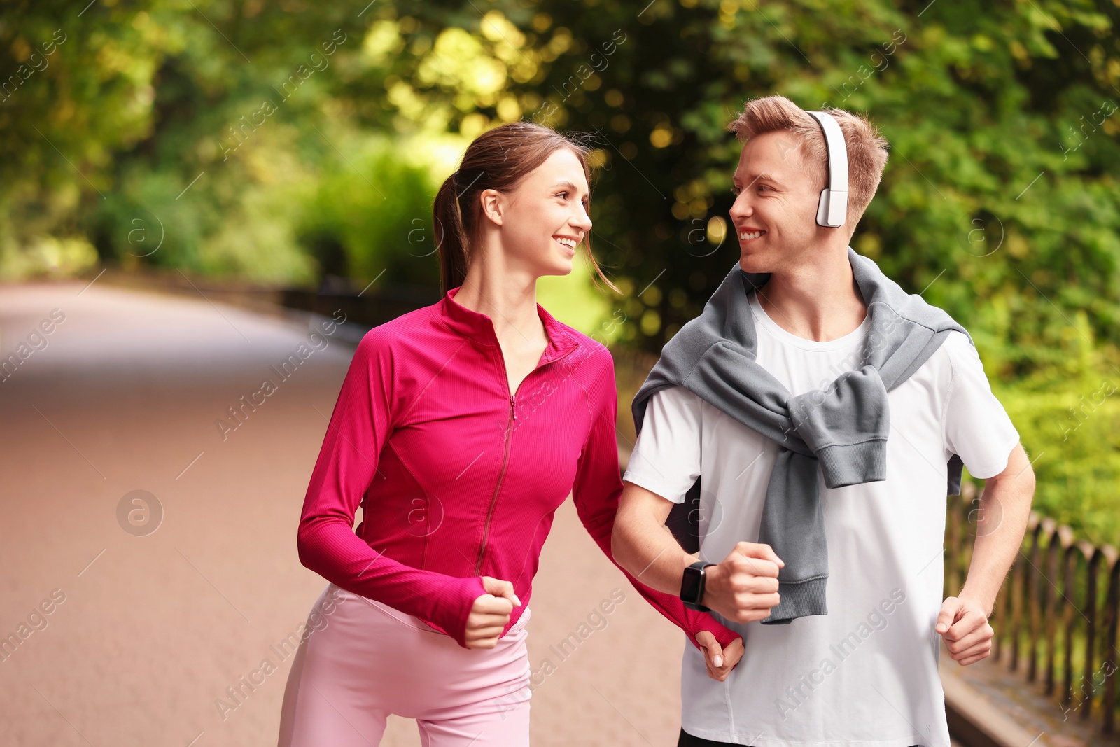 Photo of Happy couple running in park. Morning exercise