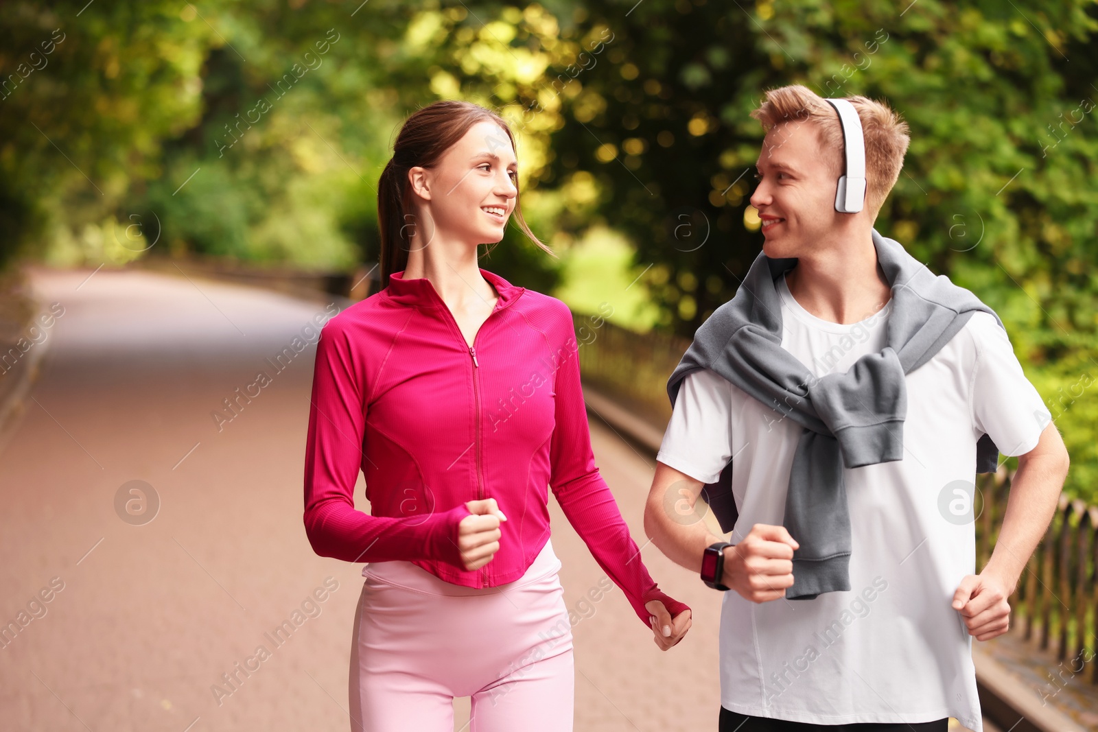 Photo of Happy couple running in park. Morning exercise