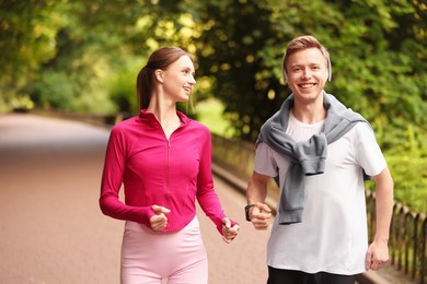 Photo of Happy couple running in park. Morning exercise