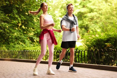 Photo of Happy couple running in park. Morning exercise