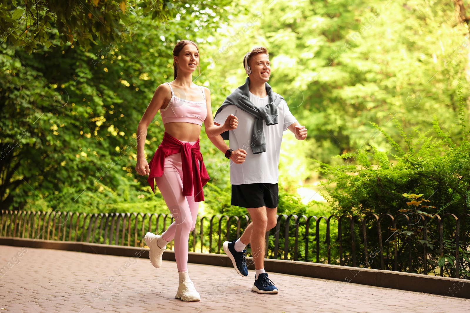 Photo of Happy couple running in park. Morning exercise