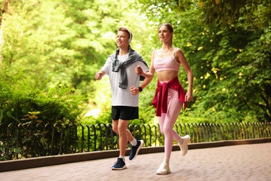 Photo of Happy couple running in park. Morning exercise