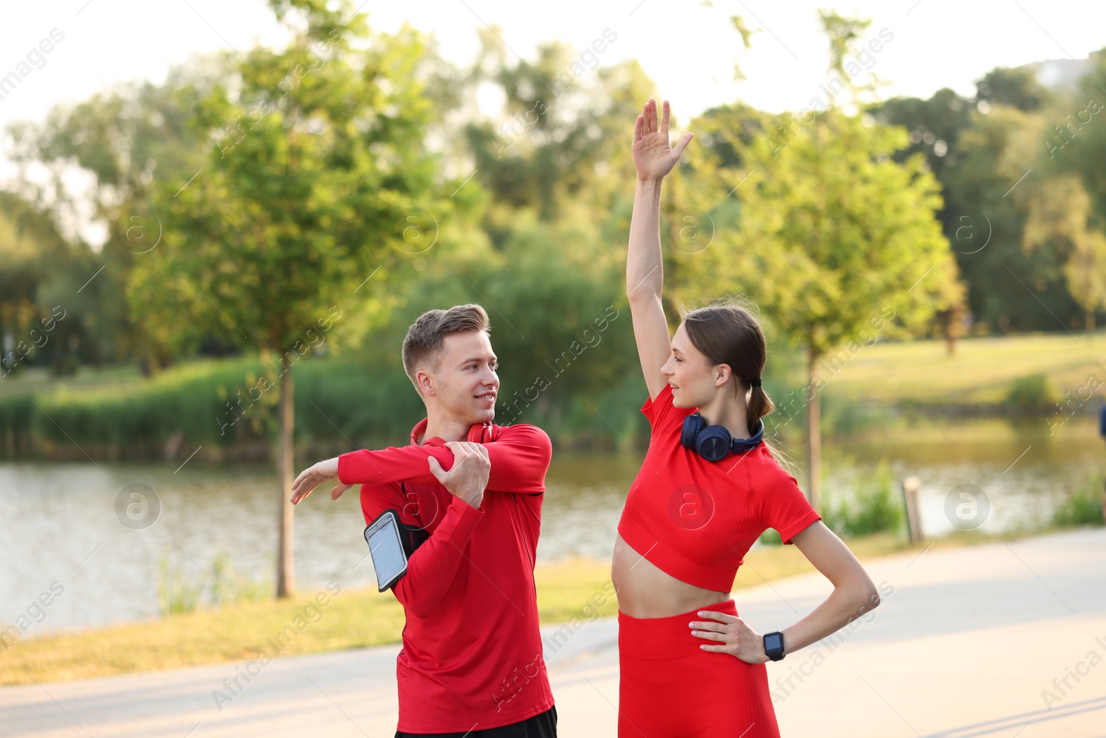 Photo of Happy couple doing morning exercise outdoors. Healthy lifestyle