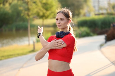 Photo of Young sportswoman doing morning exercise outdoors. Healthy lifestyle