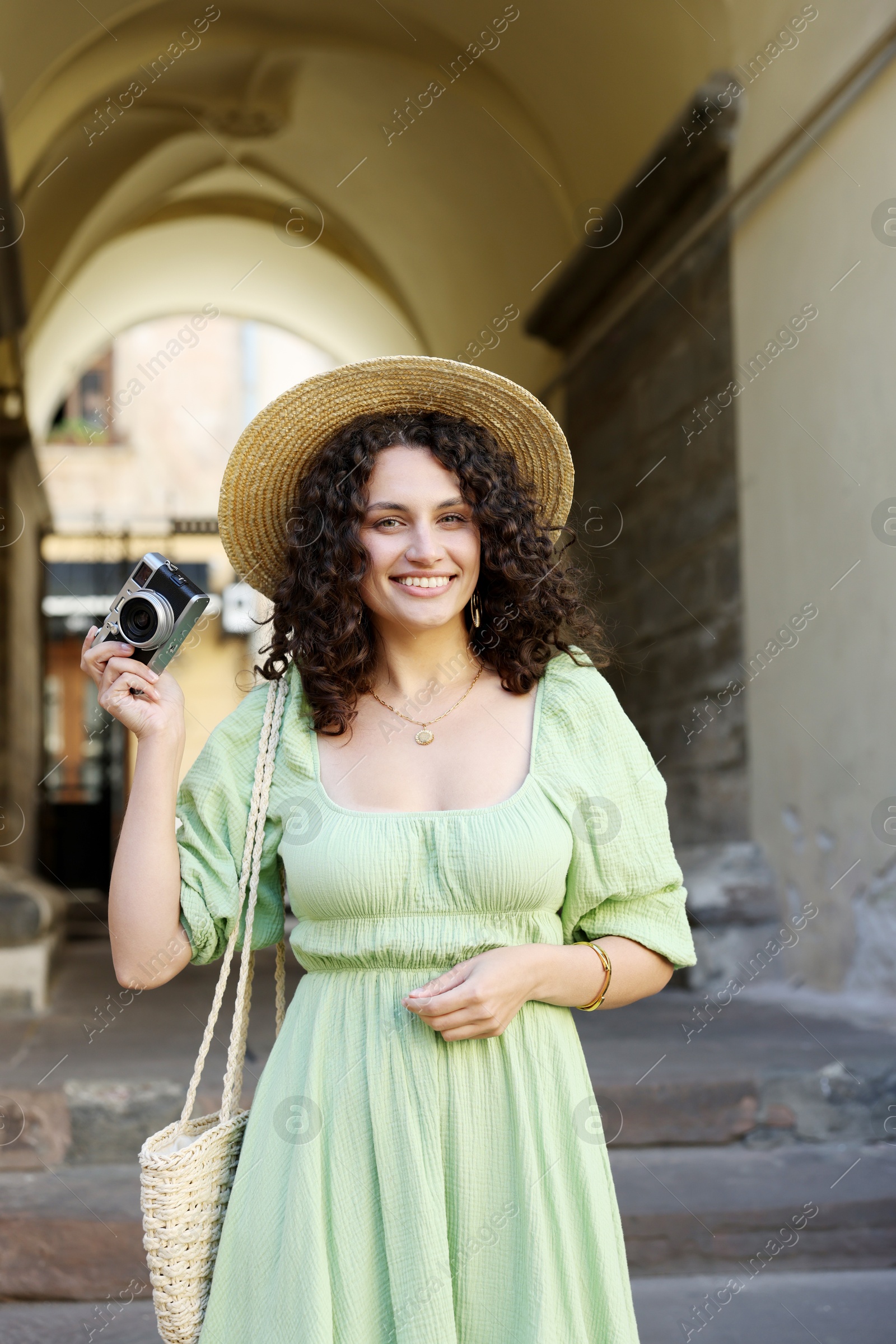 Photo of Tourist with vintage camera walking on city street
