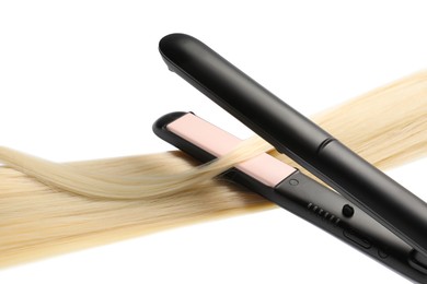 Photo of Straightener with blonde hair lock isolated on white