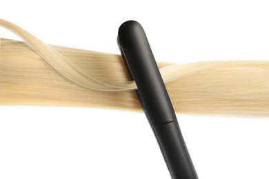 Photo of Straightener with blonde hair lock isolated on white