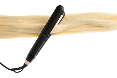 Photo of Straightener with blonde hair lock isolated on white