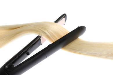 Photo of Straightener with blonde hair lock isolated on white