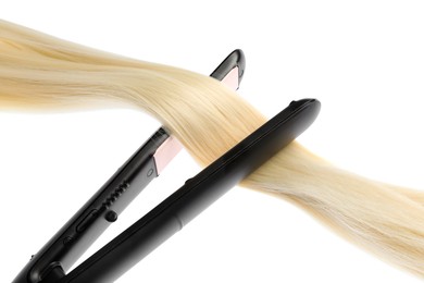 Photo of Straightener with blonde hair lock isolated on white
