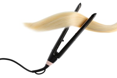 Photo of Straightener with blonde hair lock isolated on white