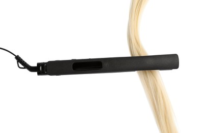 Photo of Straightener with blonde hair lock isolated on white