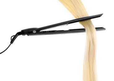 Photo of Straightener with blonde hair lock isolated on white