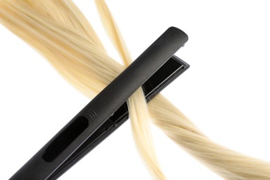 Photo of Straightener with blonde hair lock isolated on white