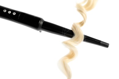 Photo of Curling iron with blonde hair lock isolated on white