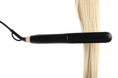 Photo of Straightener with blonde hair lock isolated on white